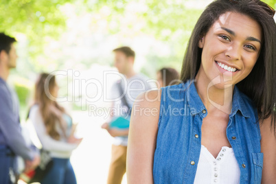 Pretty student smiling at camera outside