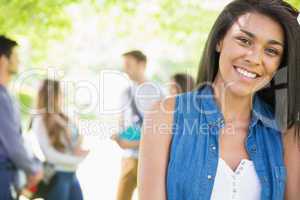 Pretty student smiling at camera outside