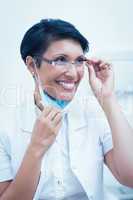 Confident female dentist smiling
