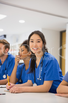 Medical student smiling at the camera during class