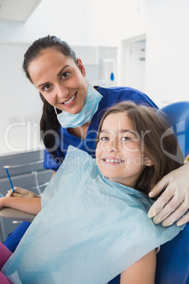 Smiling pediatric dentist with a cute young patient