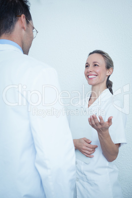 Smiling dentists in discussion