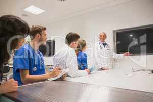 Medical professor teaching young students
