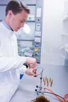Focused biochemist sealing a vial