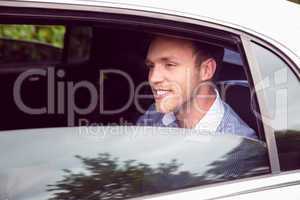 Young man talking on phone in limousine