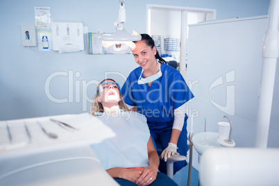 Dentist sitting over patient in the chair