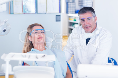 Patient and dentist smiling at camera