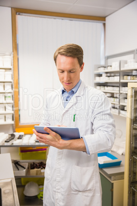 Focused pharmacist using tablet pc