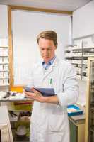 Focused pharmacist using tablet pc