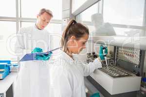 Young scientist using a pipette in chamber