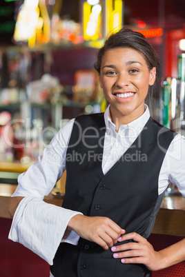 Pretty barmaid smiling at camera