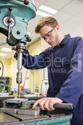 Engineering student using large drill