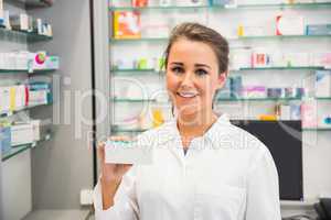 Junior pharmacist showing medicine box