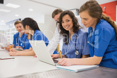 Medical student smiling at the camera during class