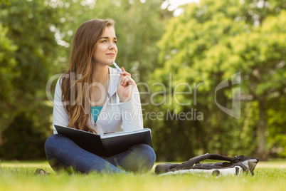 Thinking student sitting and holding book