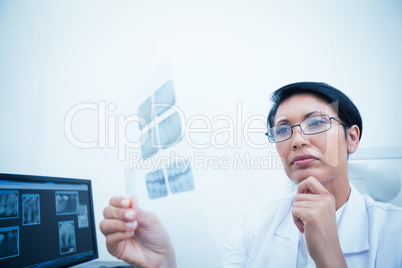 Female dentist looking at x-ray