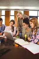 Professor teaching group of students in library