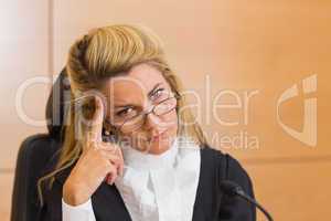 Stern judge looking at camera