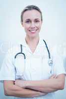 Smiling female dentist with arms crossed