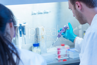 Science student using pipette in the lab