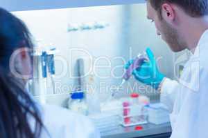 Science student using pipette in the lab