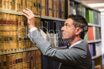 Lawyer picking book in the law library