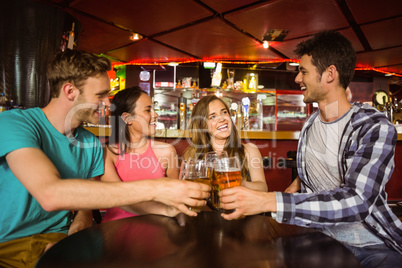 Portrait of happy friends toasting with drink and beer