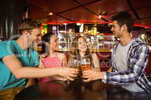 Portrait of happy friends toasting with drink and beer