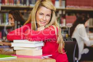Smiling mature student with stack of books