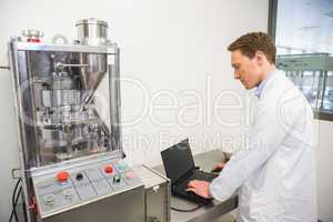 Focused pharmacist using his laptop