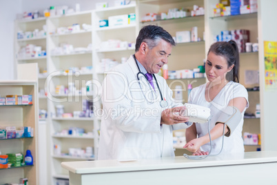 Pharmacist showing patient her blood pressure reading
