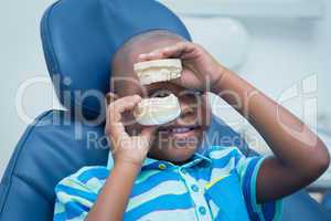 Smiling boy holding mouth model
