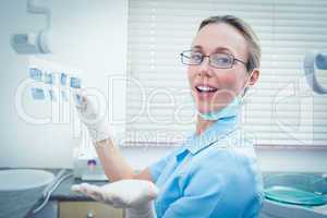Female dentist holding x-ray