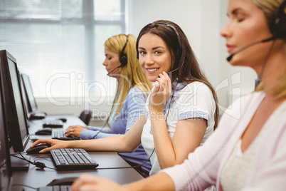 Smiling call centre agent talking on the headset