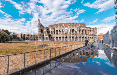 Water reflections of Colosseum with blue sky, Rome