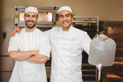 Team of bakers smiling at camera