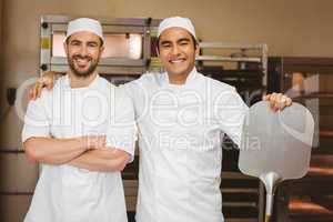 Team of bakers smiling at camera