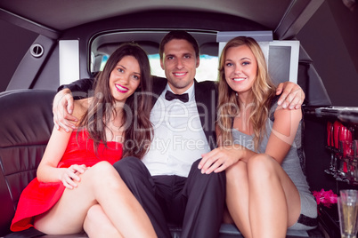Pretty girls with ladies man in the limousine
