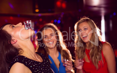 Pretty friends drinking shots together