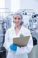 Portrait of a smiling scientist holding a clipboard