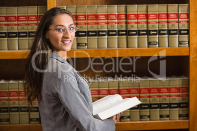 Lawyer looking at camera in the law library