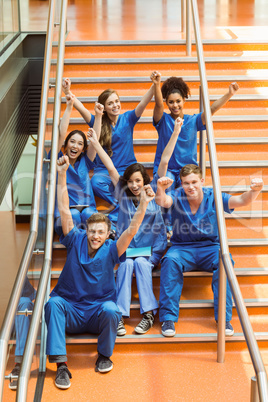 Medical students cheering on the steps