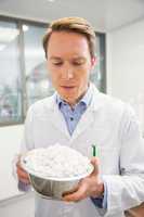 Pharmacist showing bowl of pills