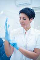 Dentist wearing surgical glove