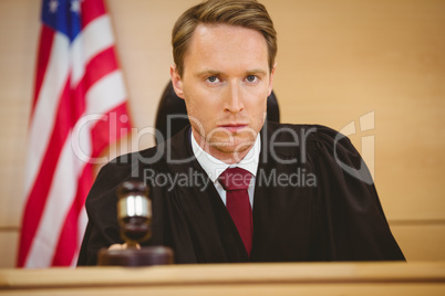 Portrait of a judge about to bang gavel on sounding block