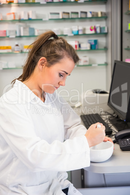 Junior pharmacist mixing a medicine