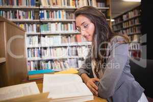 Pretty student studying in the library