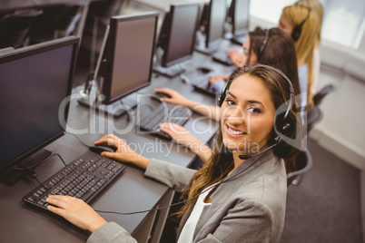 Smiling call centre agent talking on the headset