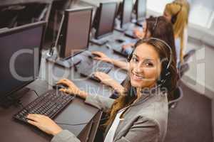 Smiling call centre agent talking on the headset