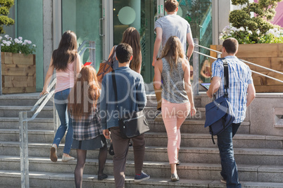 Happy students walking and chatting outside